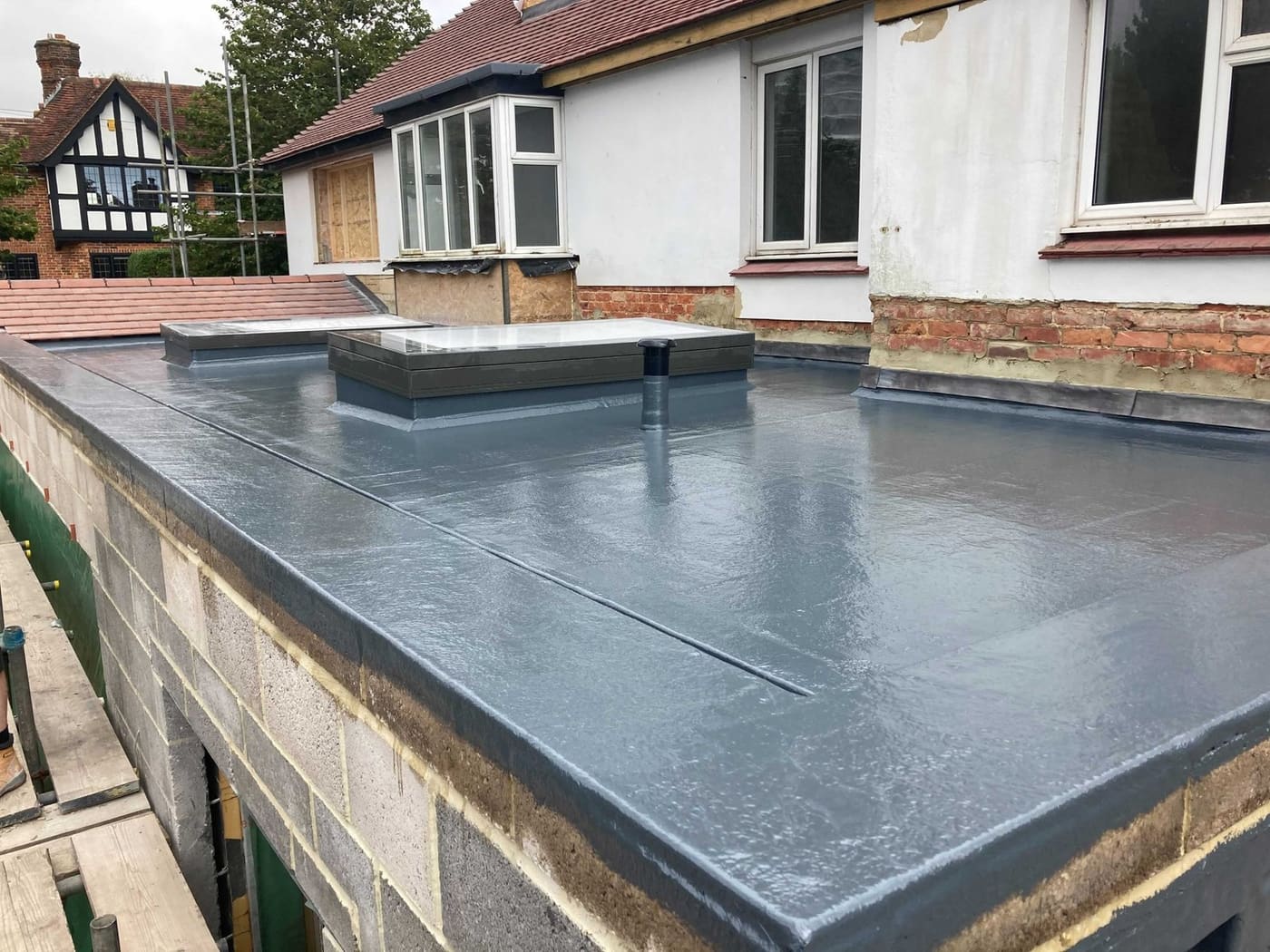 GRP flat roof on a new extension with rooflights and scaffold boards