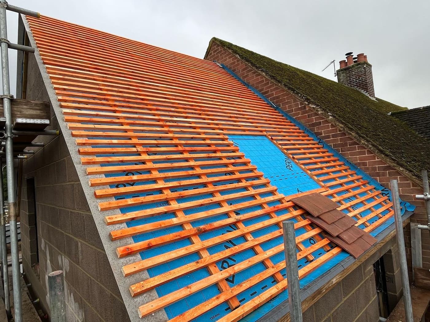 Roof re-battened over a new blue membrane, ready for tiles